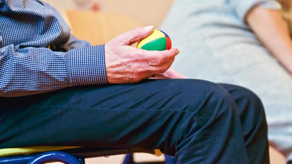 pexels photo 339619 339619 Elderly man holding a colorful therapy ball indoors, promoting relaxation and health.